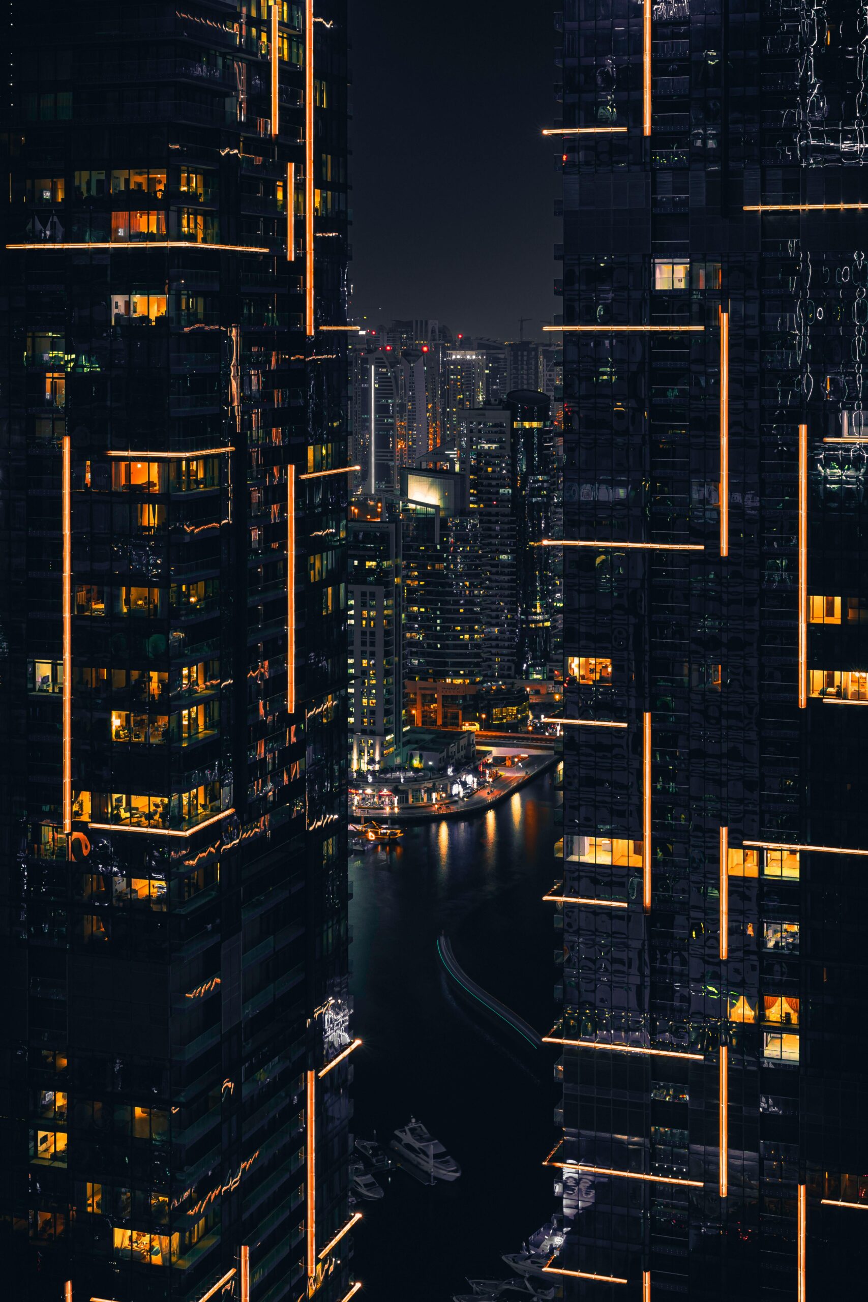 Captivating night view of Dubai skyscrapers illuminated against the dark sky. Perfect for tech and urban themes.